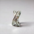 Silver and rose gold metal cross ring with micro-inlaid zircon detailing in heart and geometric design