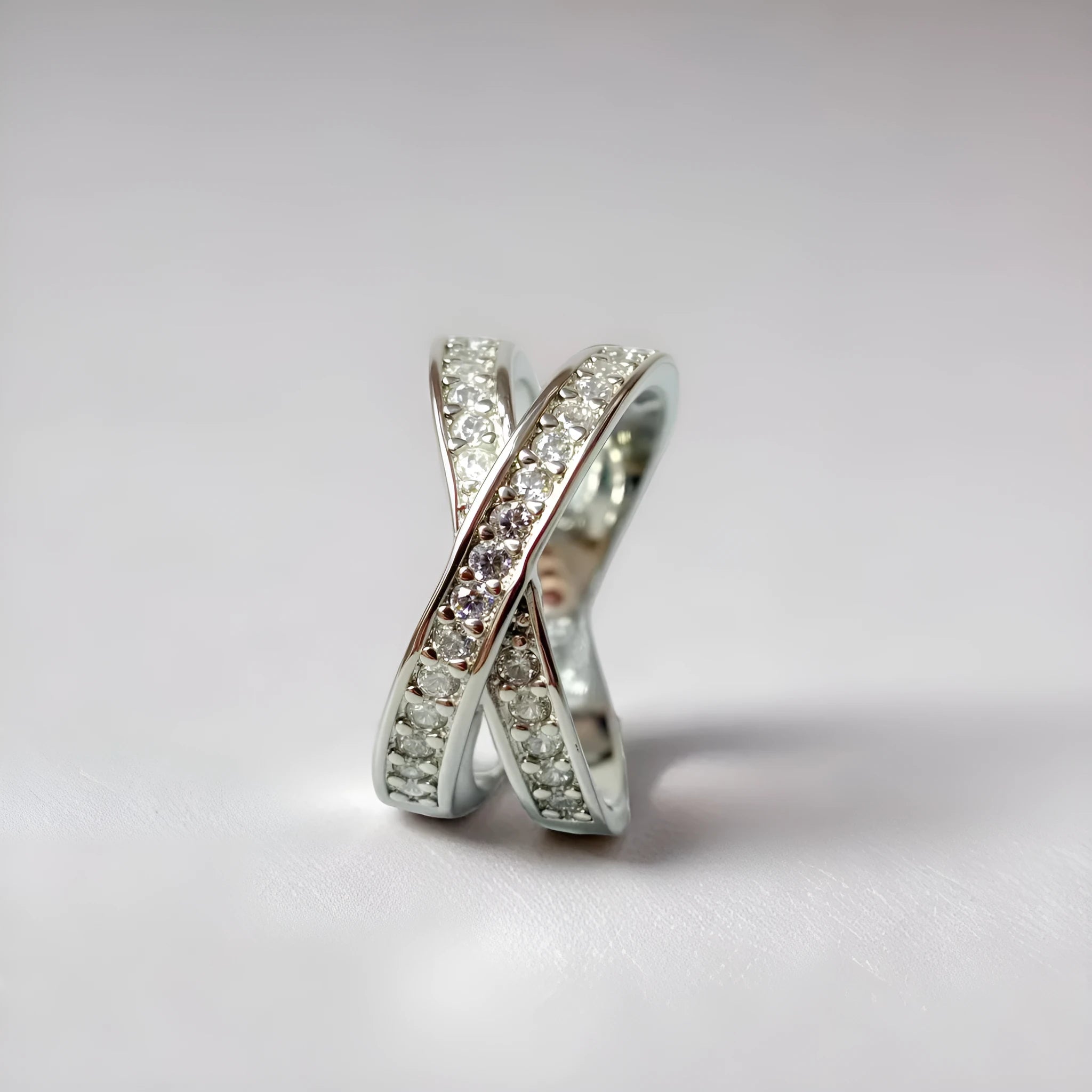 Silver and rose gold metal cross ring with micro-inlaid zircon detailing in heart and geometric design