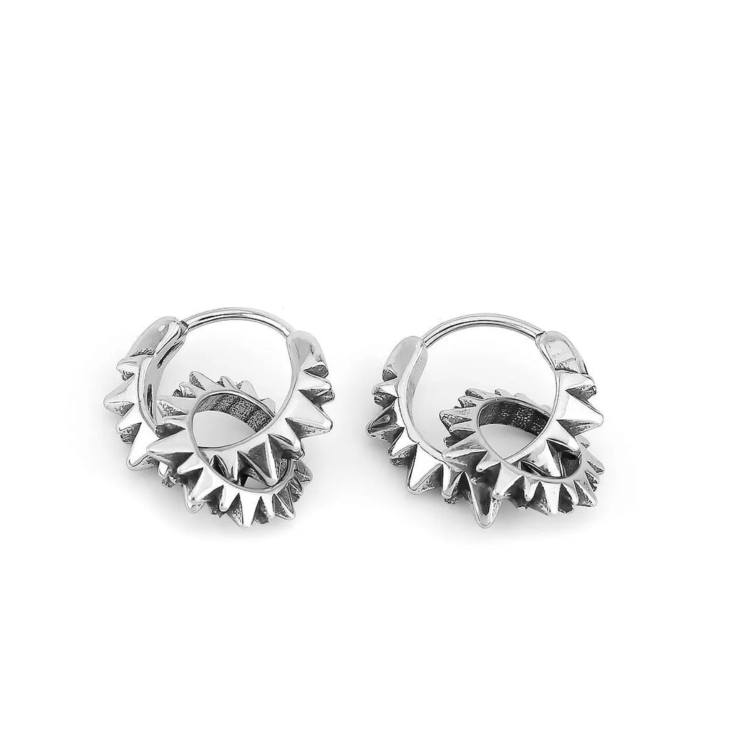 A pair of polished stainless steel round ring earrings with a titanium steel plating in a steel colour.