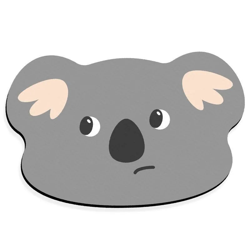 Cartoon animal diatomaceous earth bathroom mat in alien shape on a bathroom floor.