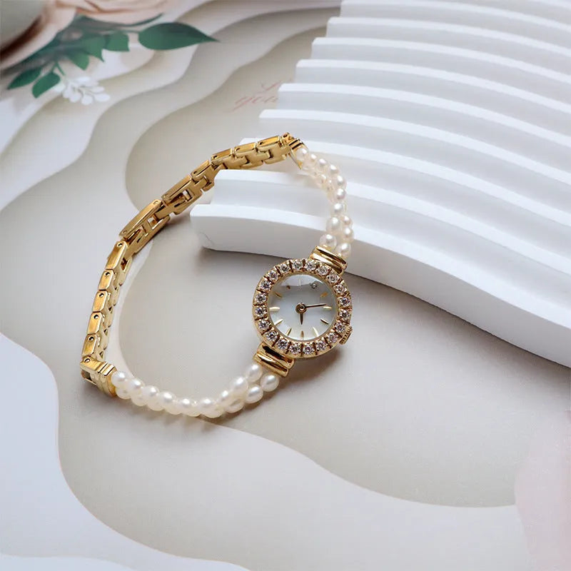 Women's light gold bracelet watch with freshwater pearls and 18mm round dial