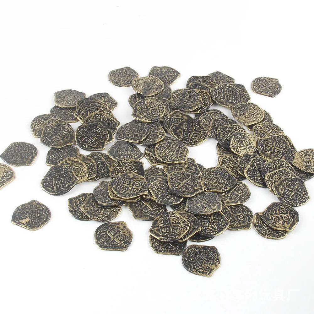 A pile of plastic Roman coins with a metallic gold finish, part of a 100-piece set for treasure-themed parties.