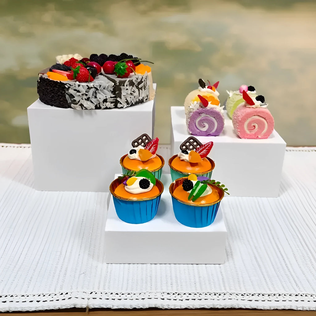 White plastic Suit Cube dessert display stand with six modular pieces arranged in multi-level configuration