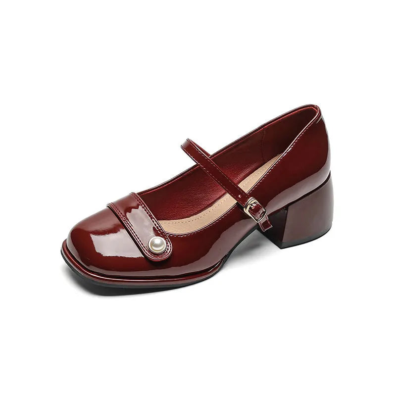 Women's apricot patent leather chunky heel pumps with a buckle fastening and square toe.