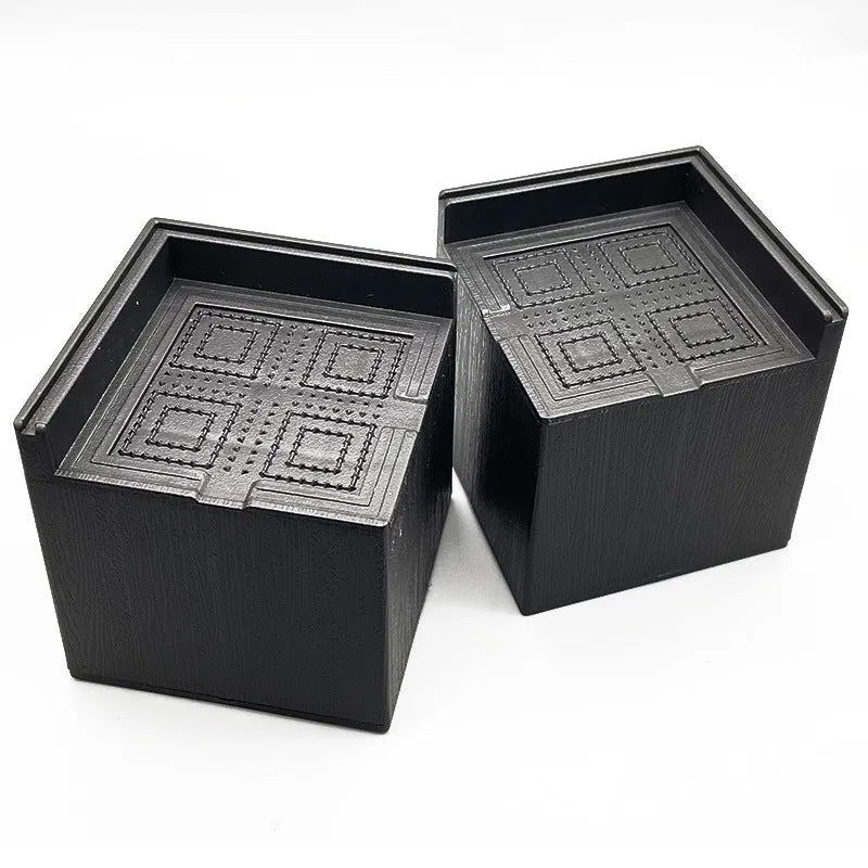 Four black plastic furniture riser mats for increasing bed and sofa height