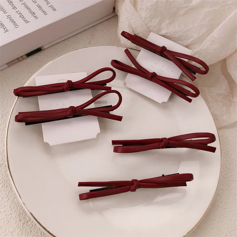 Wine red leather bow barrettes hair clips showing handcrafted bow design