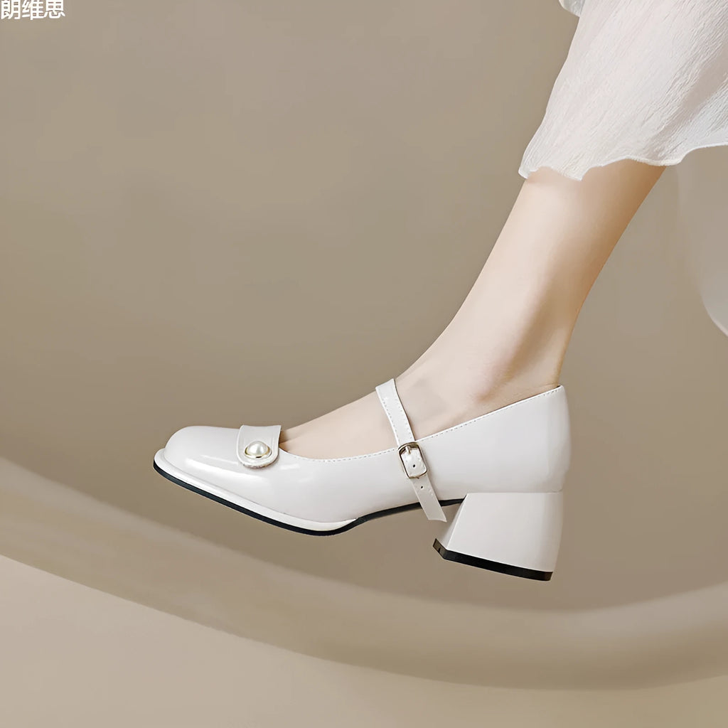 Women's apricot patent leather chunky heel pumps with a buckle fastening and square toe.