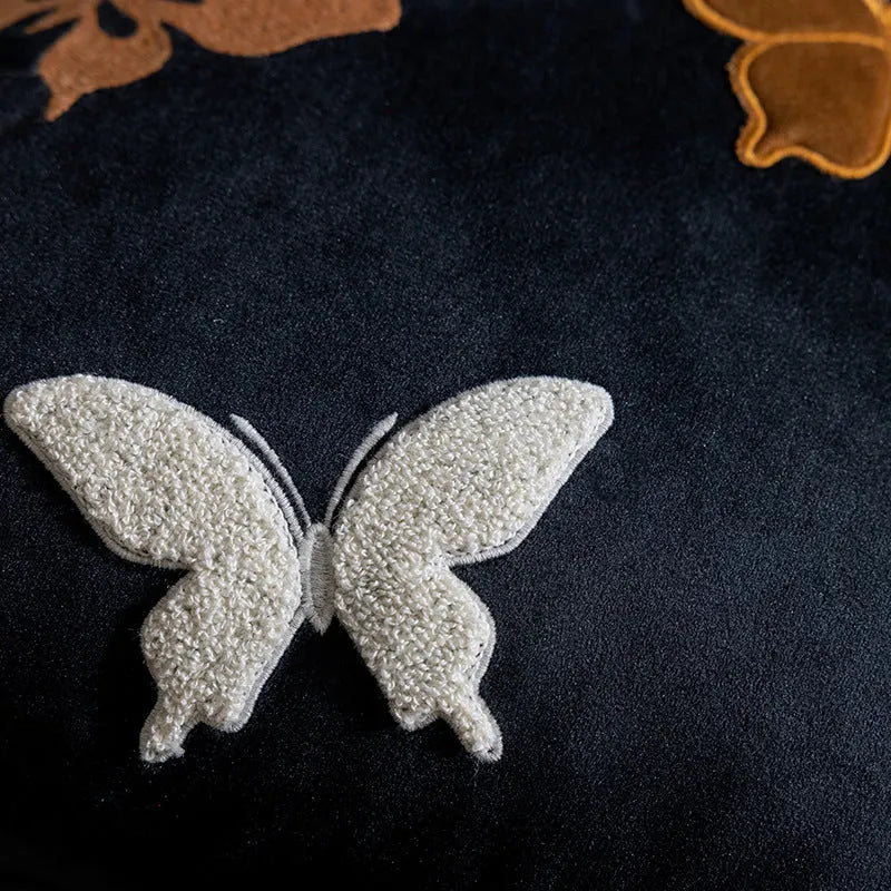 Square beige cushion with black butterfly embroidery in a Chinese style, 45cm by 45cm.