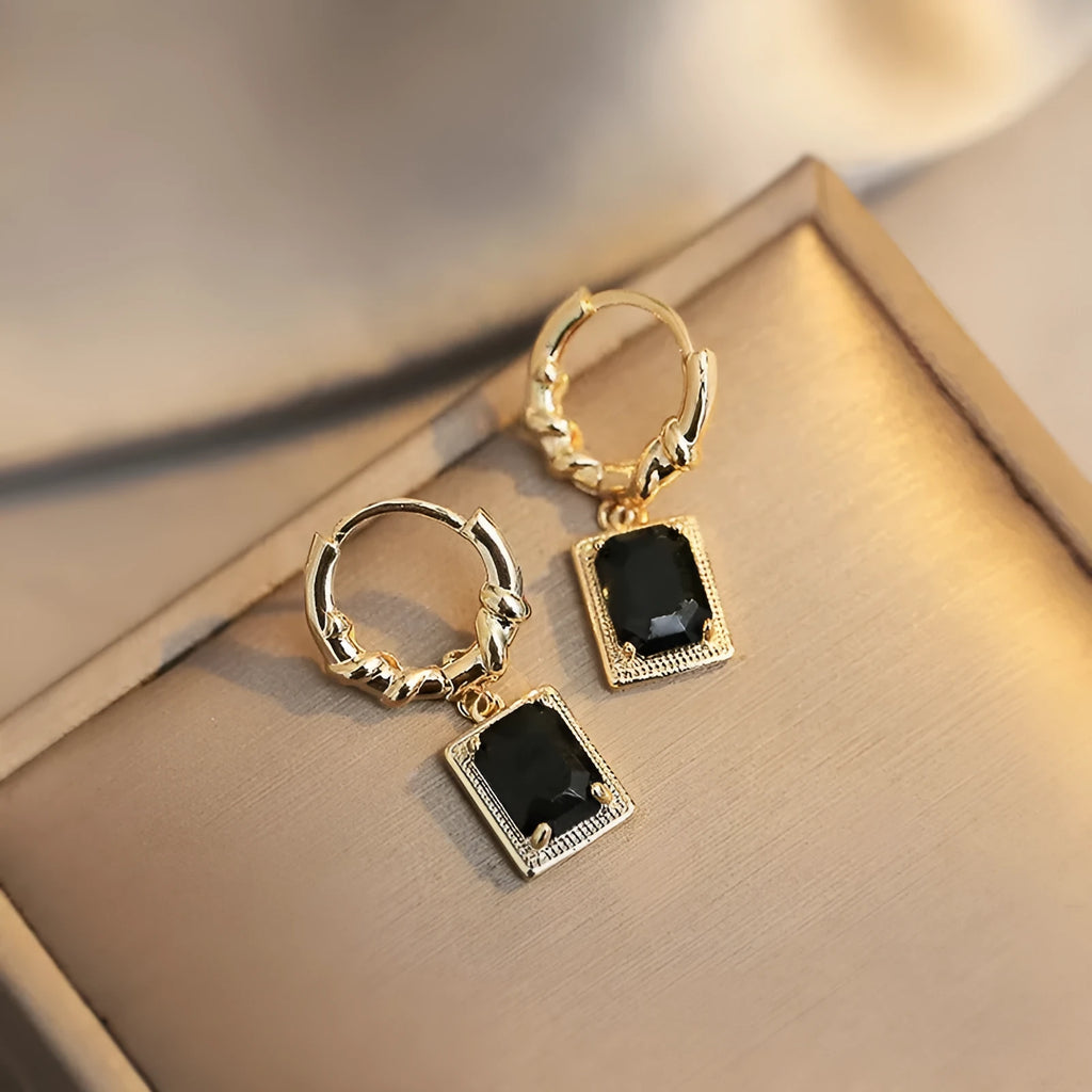 A pair of black zircon geometric copper French court earrings with a quadrilateral shape.