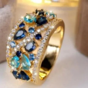 Women's hollow fashion ring in copper with stone accents, shown in gold and platinum colour options.