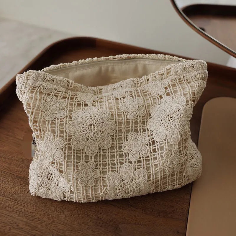 Handmade corduroy cosmetic bag with crocheted hollow flower and ethnic embroidery design.