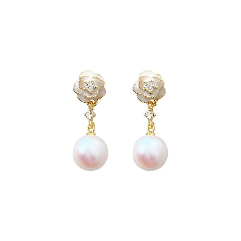 Close-up of a pair of camellia flower stud earrings for women in alloy metal.