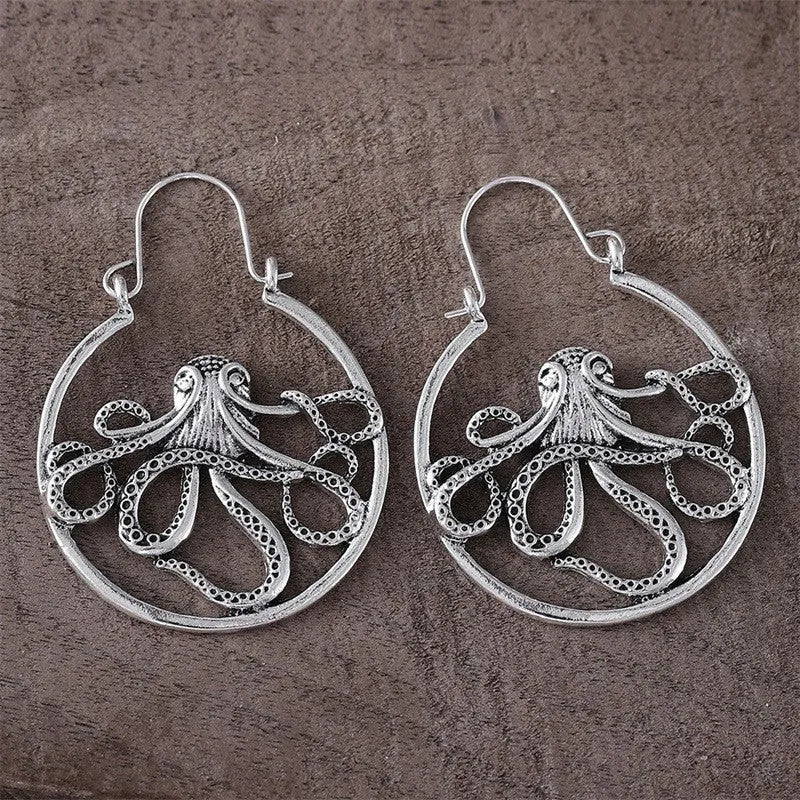A pair of vintage antique silver octopus earrings with detailed animal modelling and a retro style.