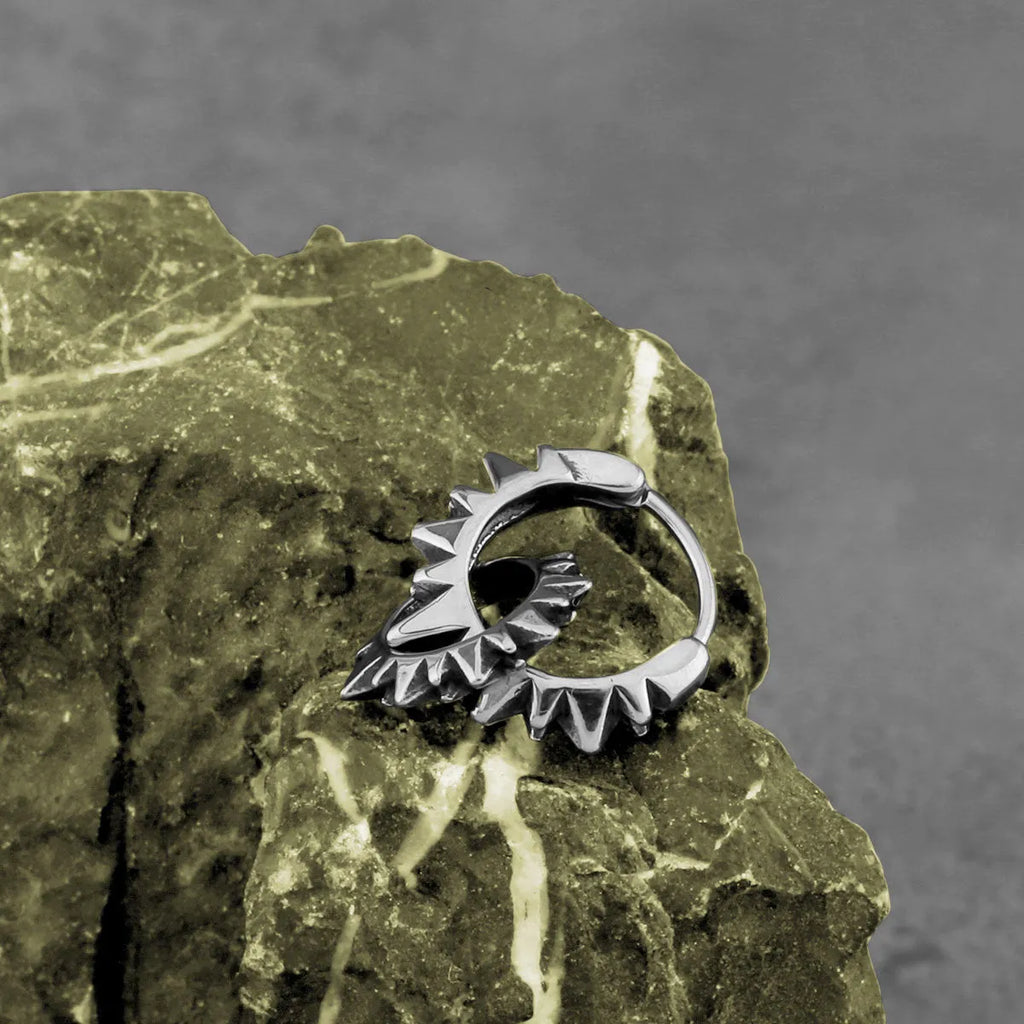 A pair of polished stainless steel round ring earrings with a titanium steel plating in a steel colour.