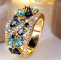 Women's hollow fashion ring in copper with stone accents, shown in gold and platinum colour options.