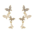 A pair of gold-coloured copper earrings with four detailed butterfly designs in a drop style.