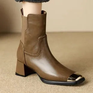 Women's brown cowhide Martin boots with high heel and side zipper, featuring decorative metal elements