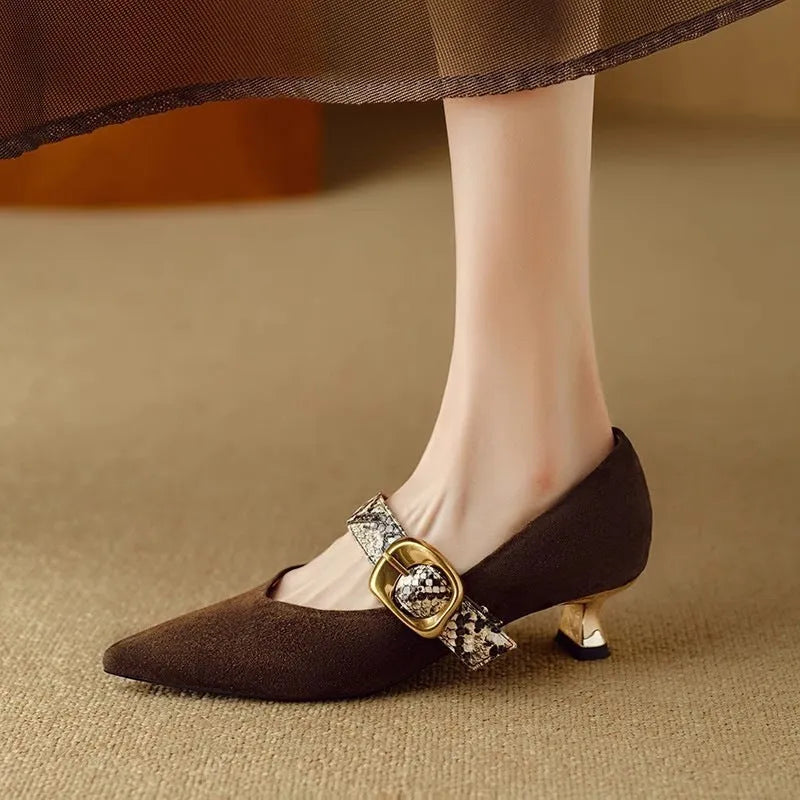 Women's black pointed stiletto heels with a buckle fastening on a matte upper.