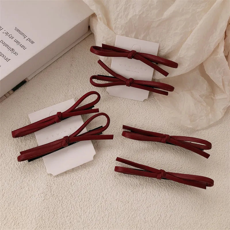 Wine red leather bow barrettes hair clips showing handcrafted bow design
