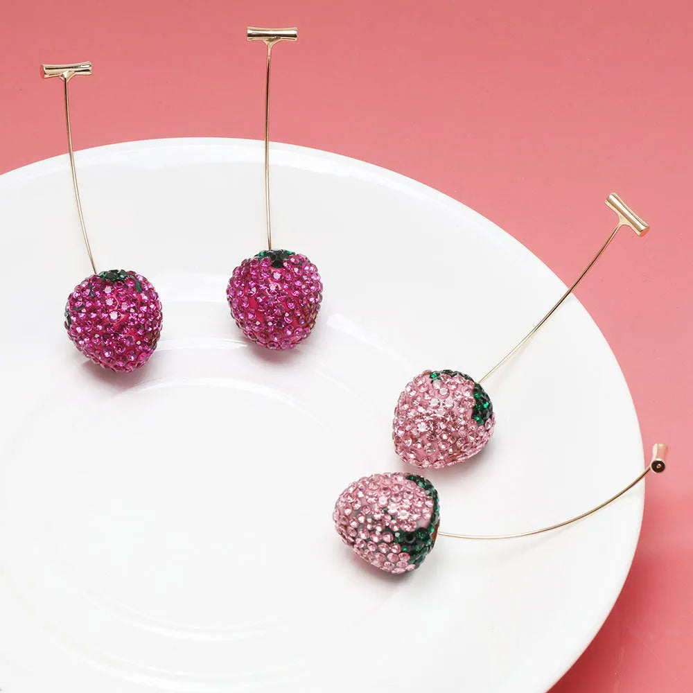 Close-up of geometric spot-drill strawberry stud earrings in red zinc alloy, shown on a plain background.