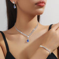 Claw chain necklace and earrings set with drop-shaped rhinestone pendants in multiple colour options