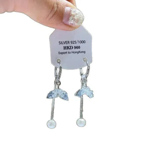 Geometric alloy ear clips with heart shape, rhinestone stars, and tassel details on a white background.
