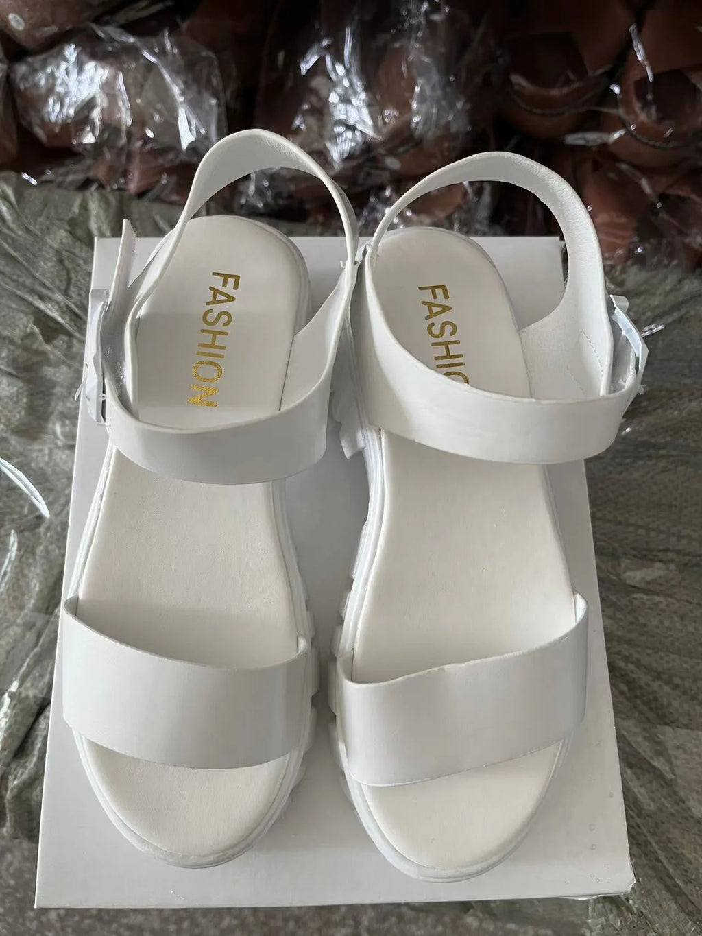 Beige women's peep toe platform sandals with ankle-strap buckle on a neutral background.