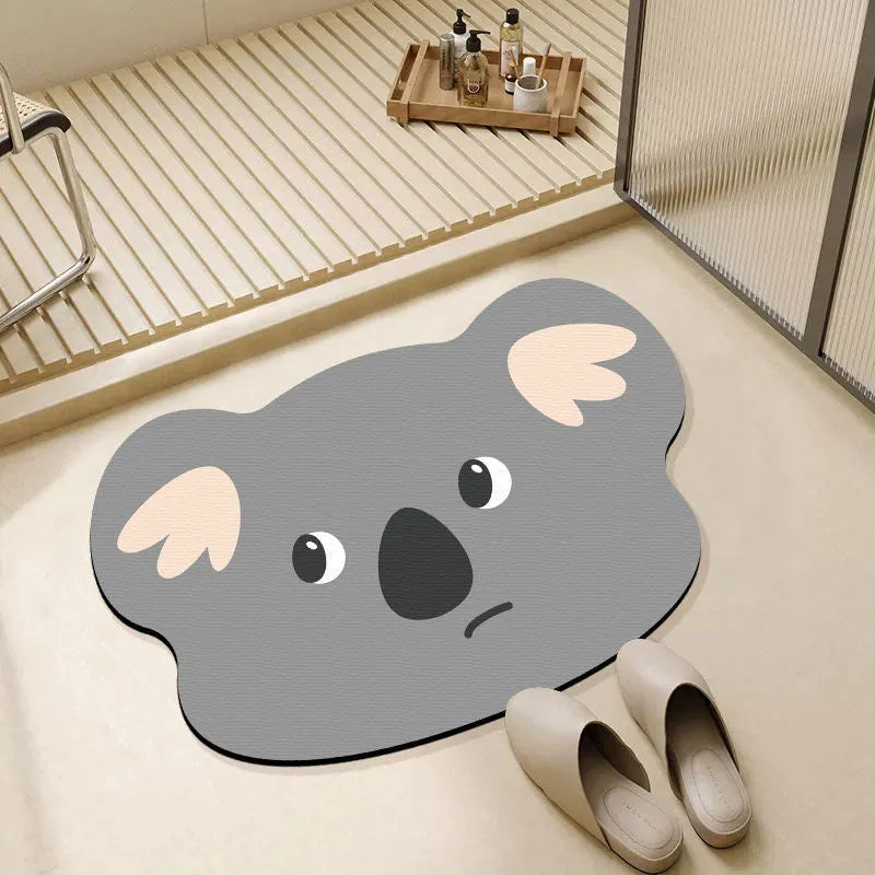 Cartoon animal diatomaceous earth bathroom mat in alien shape on a bathroom floor.