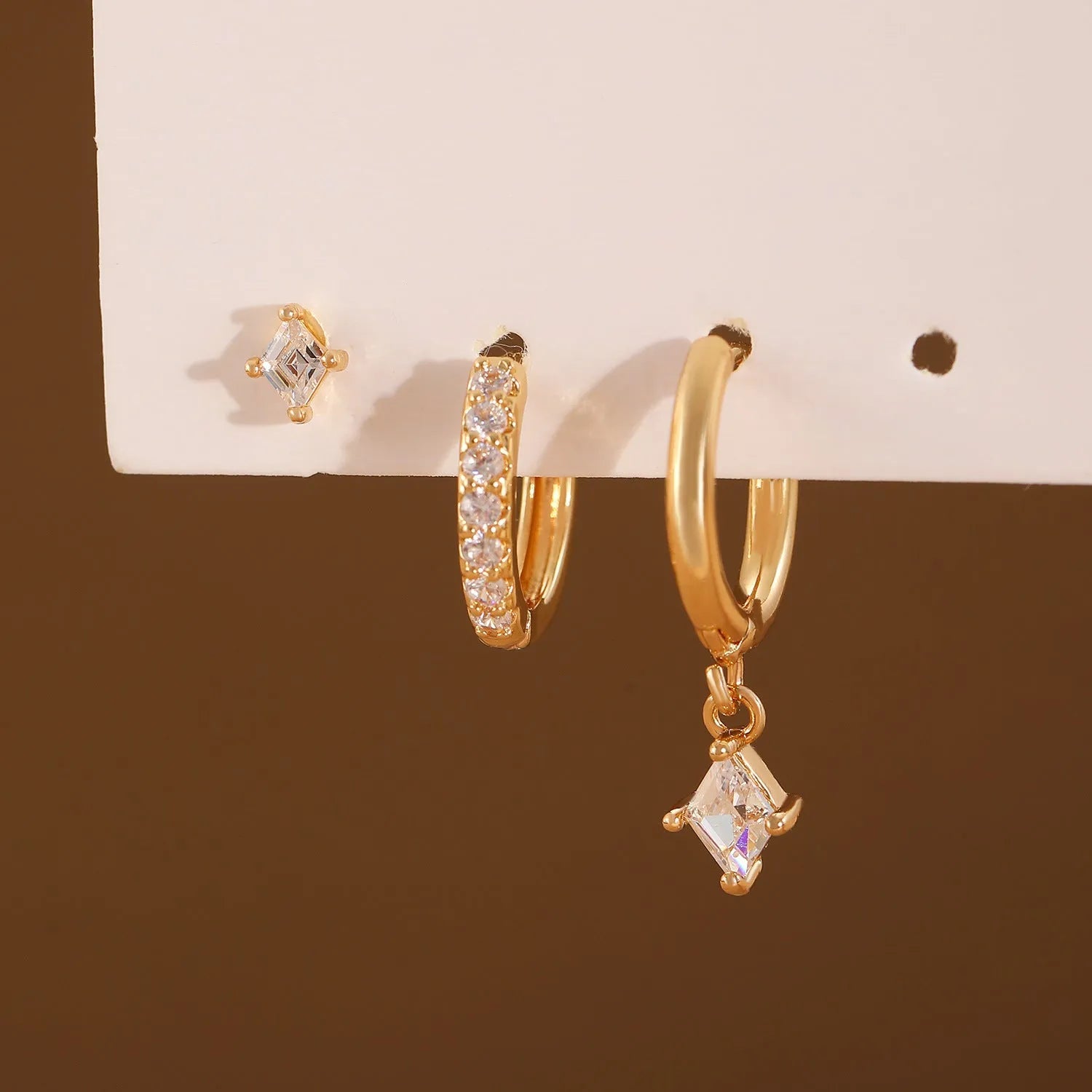 Ladies three-piece earring set showing ear ring, stud earring and ear clip with zircon diamond geometry pendants