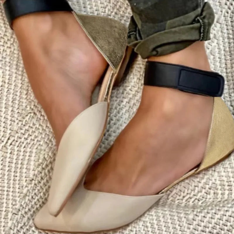 Women's flat-heel sandals with velcro straps and a hollowed upper design, shown in a beige colour.