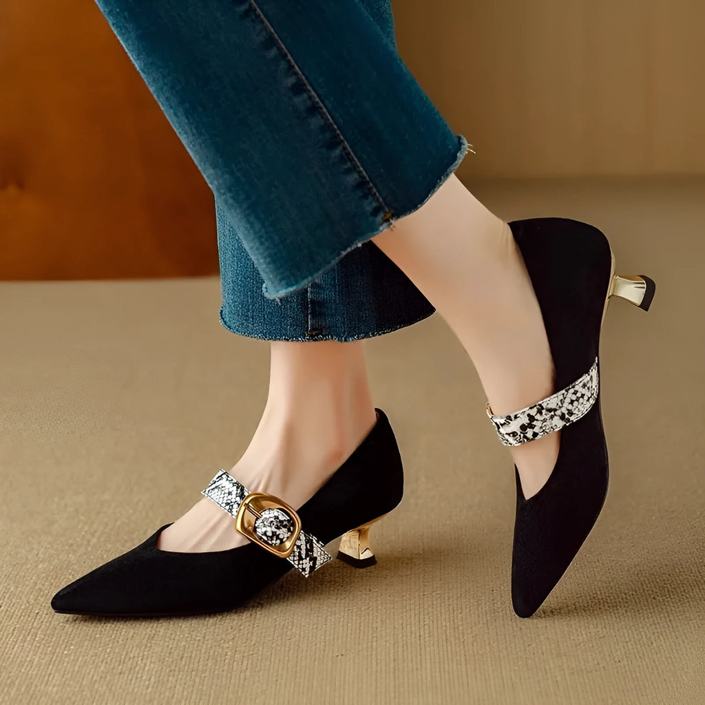 Women's black pointed stiletto heels with a buckle fastening on a matte upper.