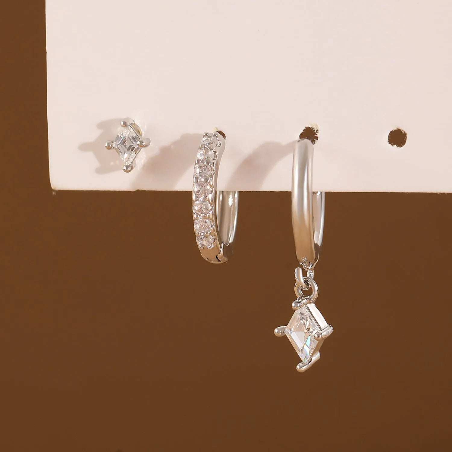 Ladies three-piece earring set showing ear ring, stud earring and ear clip with zircon diamond geometry pendants