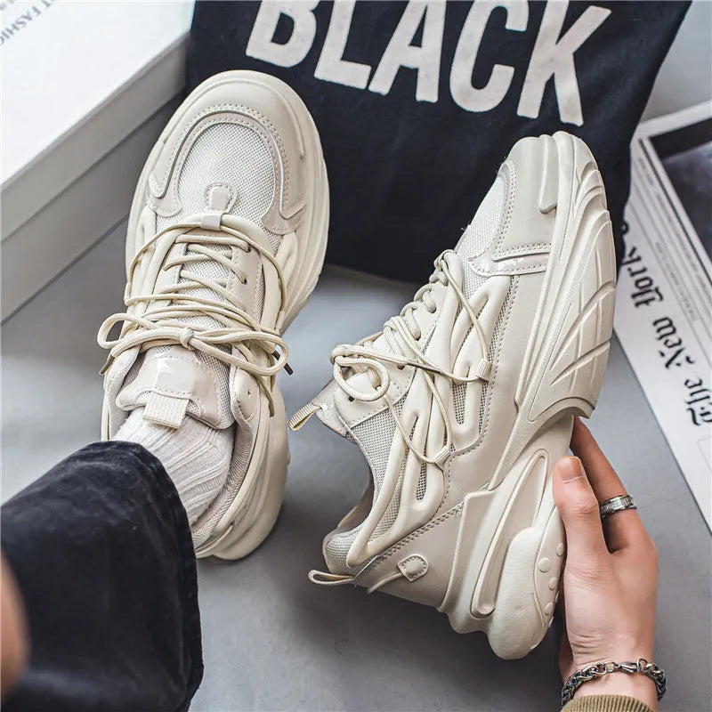 Men's low-top sneaker in beige with mesh PU leather upper and lace-up design on a rubber sole.