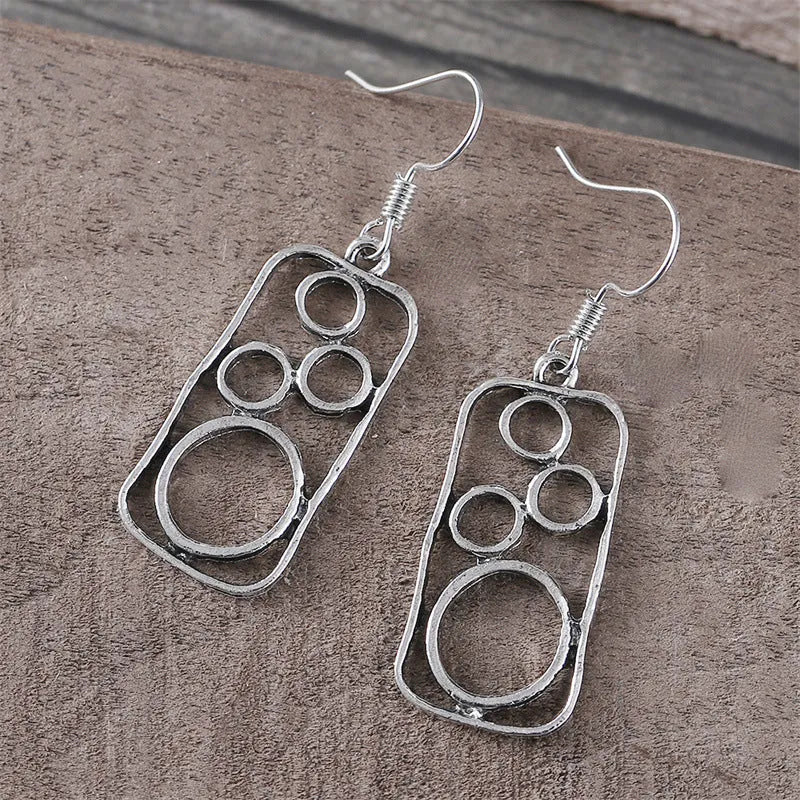 A pair of geometric round earrings with an irregular square shape in antique silver finish.