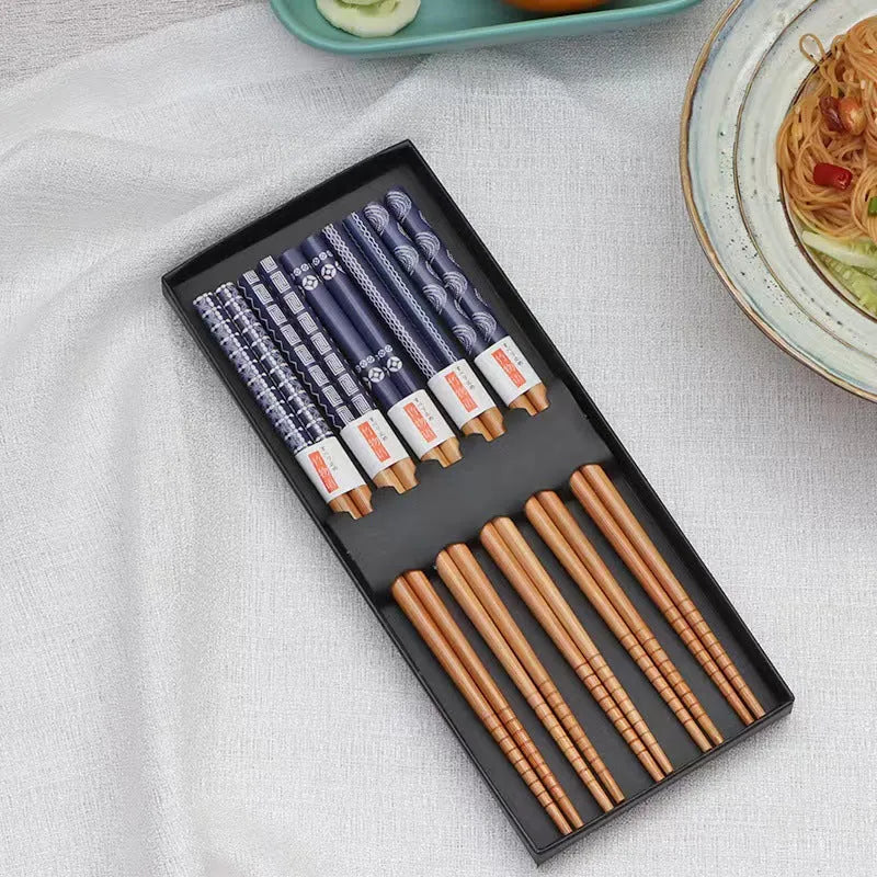 Set of five Japanese style patterned bamboo chopsticks showing lucky cat and pool elegant blue cartoon designs.