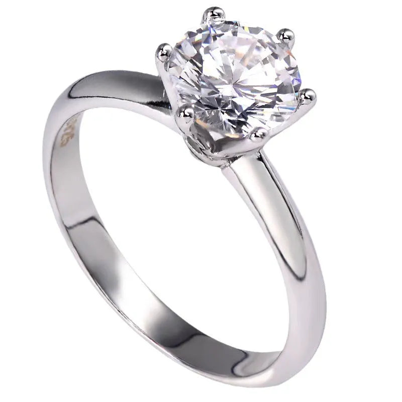 White gold plated six-claw zircon ring on a geometric white copper band.