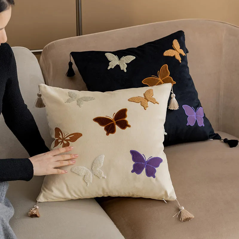 Square beige cushion with black butterfly embroidery in a Chinese style, 45cm by 45cm.