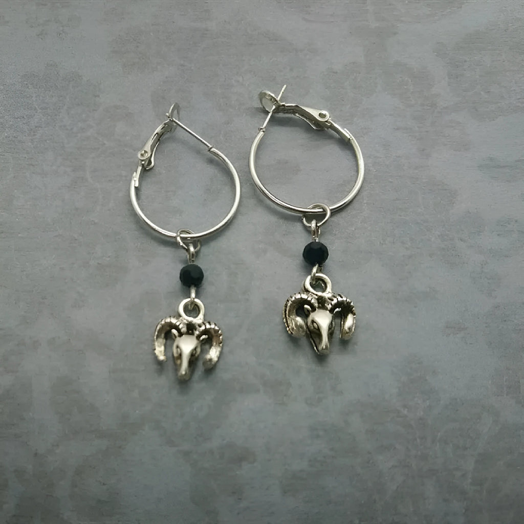 A pair of silver-coloured alloy round ring earrings with Tibetan antelope design inspiration.