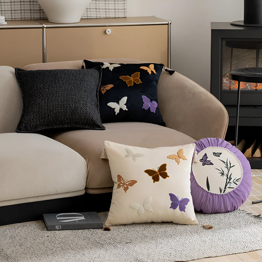 Square beige cushion with black butterfly embroidery in a Chinese style, 45cm by 45cm.