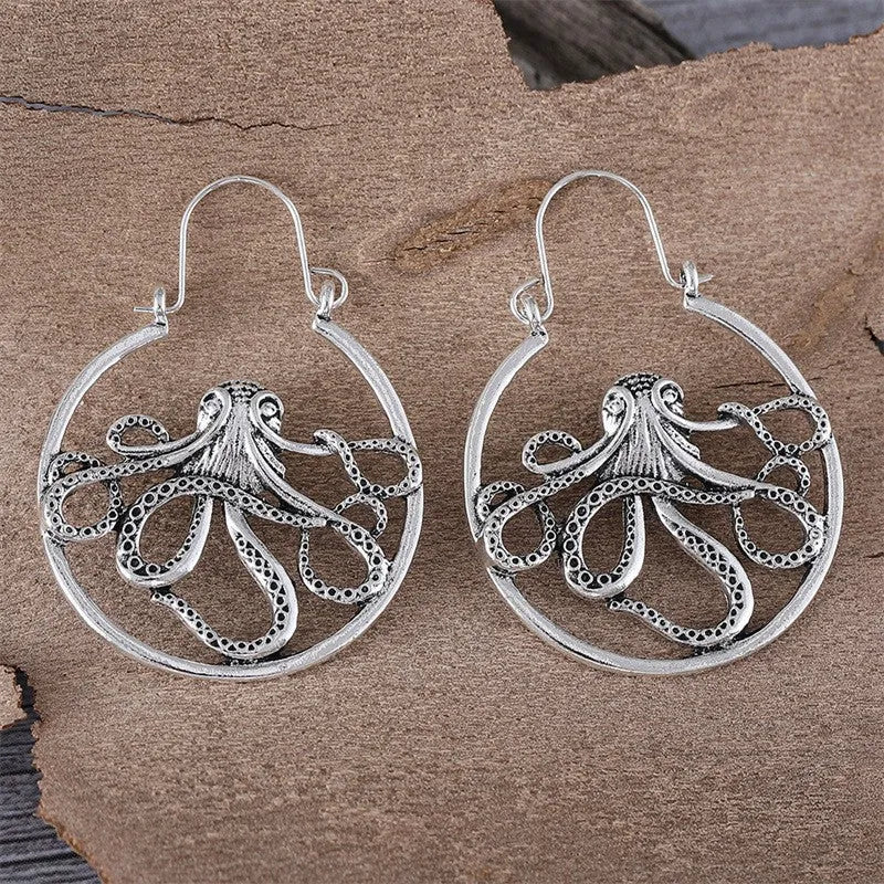 A pair of vintage antique silver octopus earrings with detailed animal modelling and a retro style.