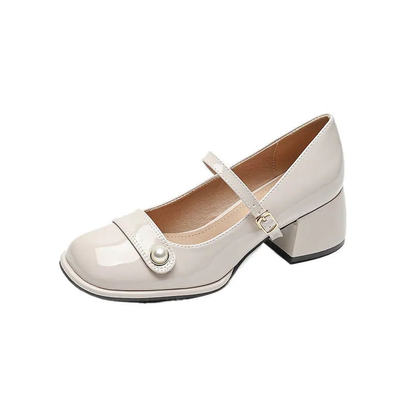 Women's apricot patent leather chunky heel pumps with a buckle fastening and square toe.