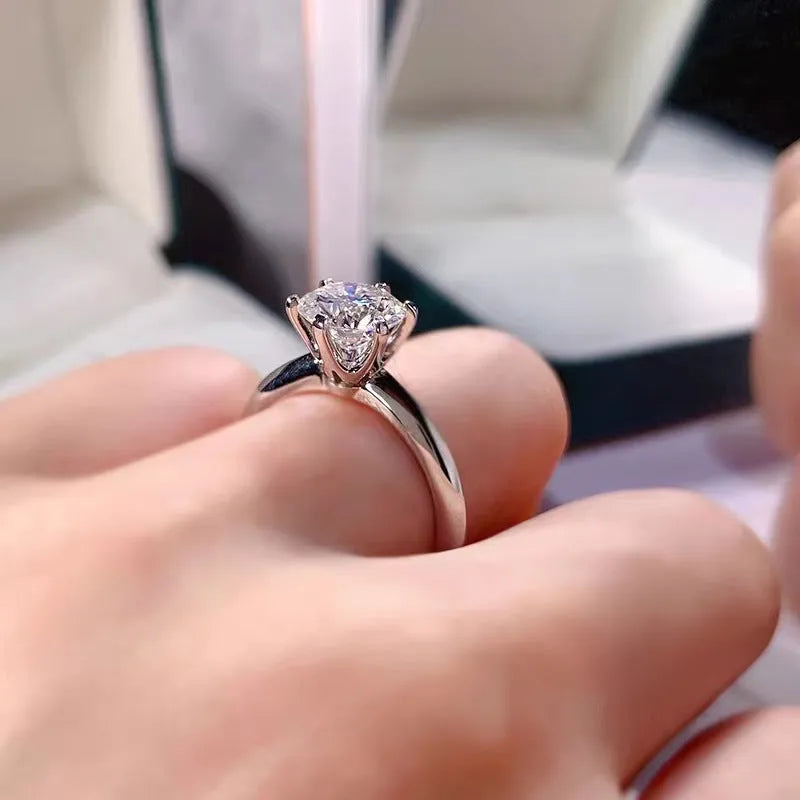 White gold plated six-claw zircon ring on a geometric white copper band.