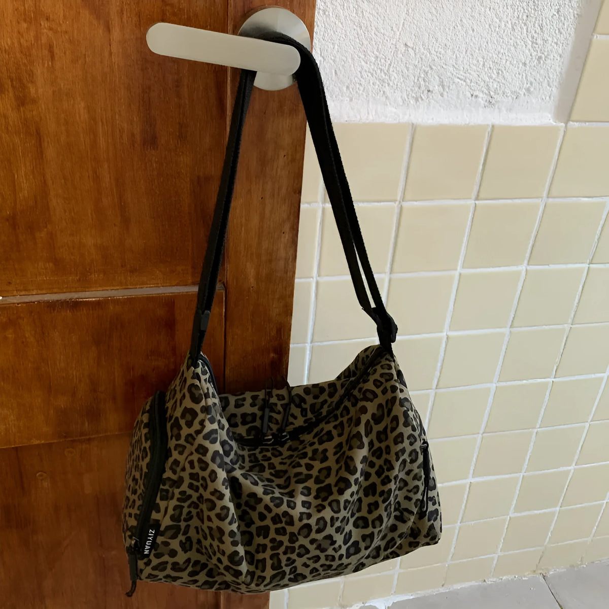 Leopard print sports style shoulder messenger bag with cross-body strap and large capacity design
