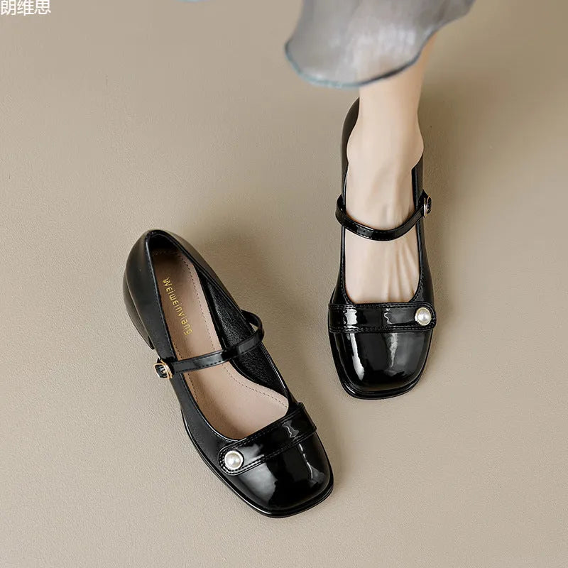Women's apricot patent leather chunky heel pumps with a buckle fastening and square toe.