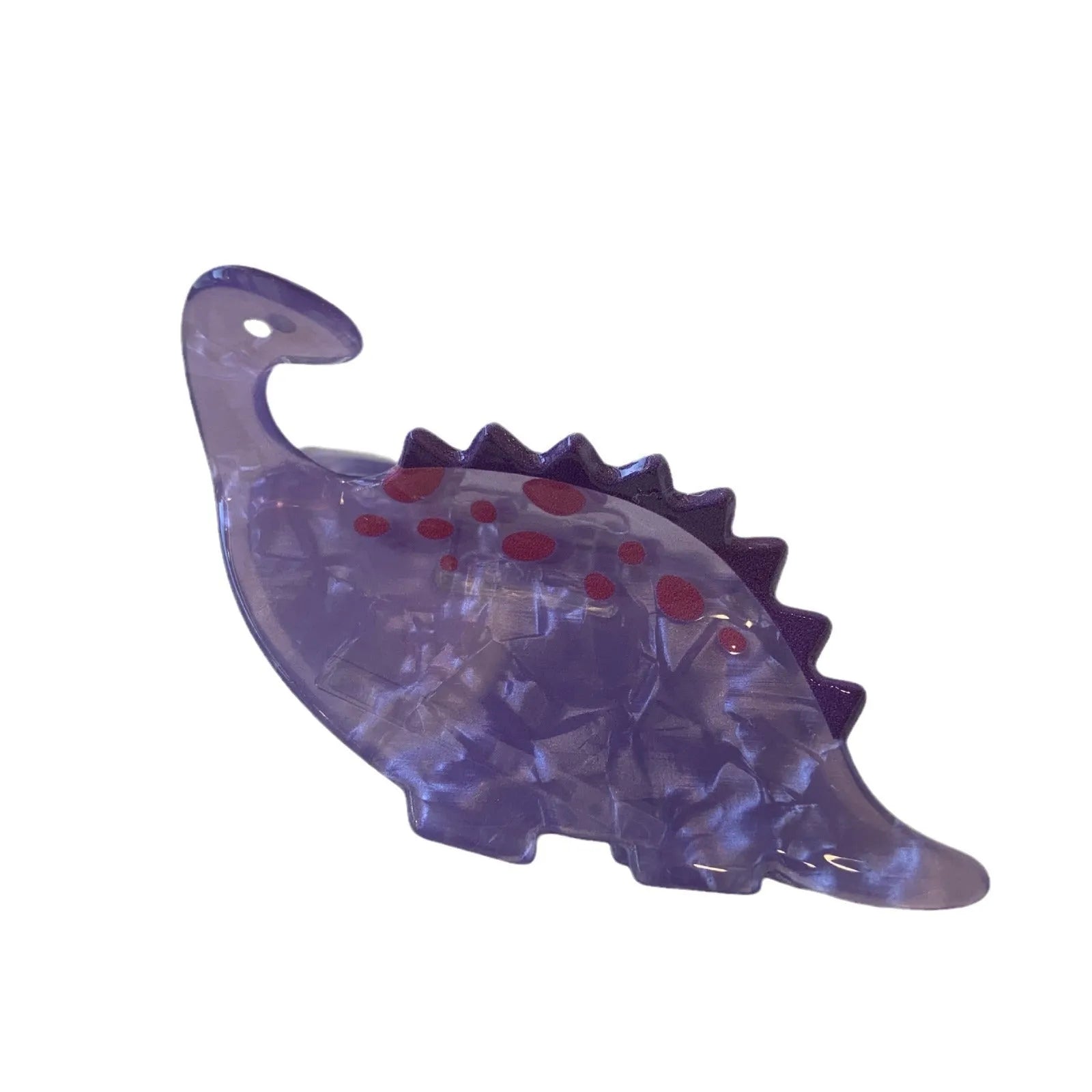 Dinosaur-shaped acrylic jaw clip hair grip in assorted colours including blue, brown, green, pink, and purple.