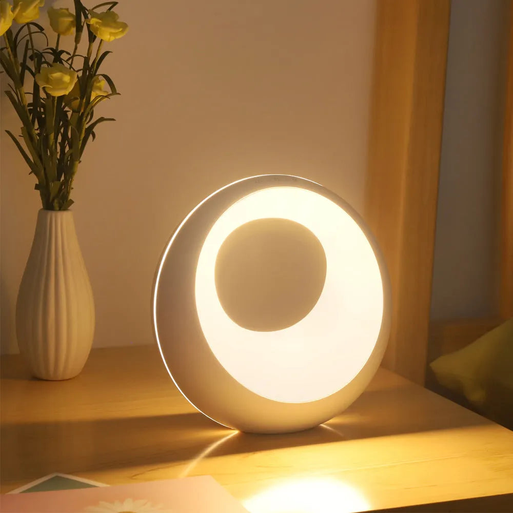 Small white desk lamp with remote control showing RGB colour changing ambient light display
