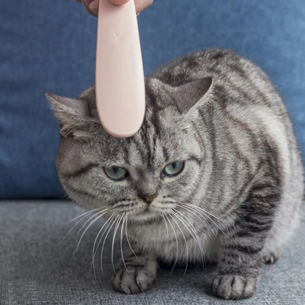 Grey ABS plastic cat comb with tongue massager design showing narrow and wide ends for pet grooming