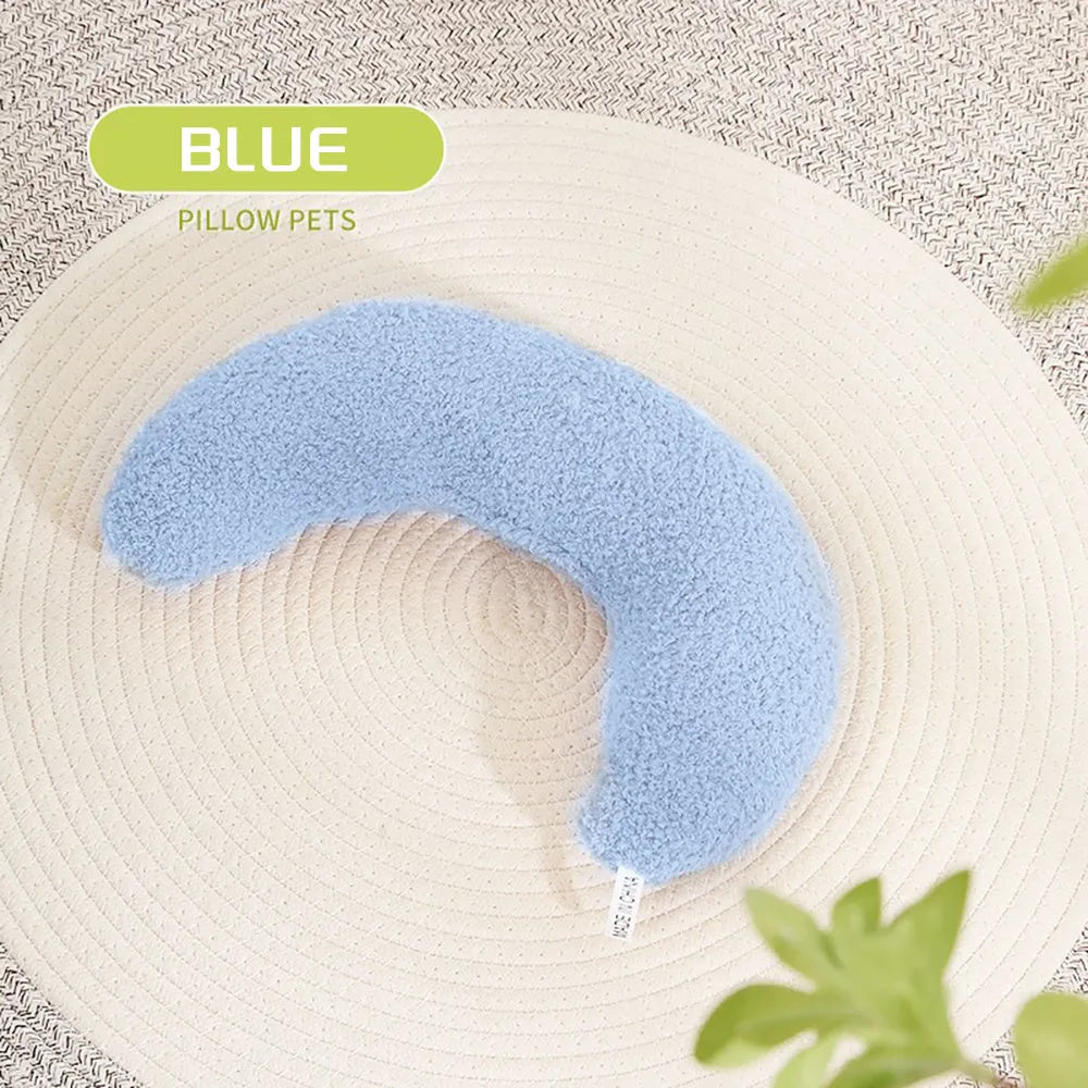 U-shaped blue cat pillow with adjustable fabric collar on a sofa