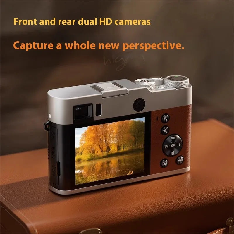 Black 5K HD digital camera with dual lenses and an optical viewfinder on a table with its accessories.