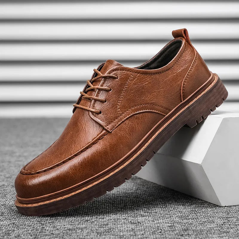 Men's black and brown casual leather shoes with a round toe and flat rubber sole.